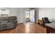 Comfortable living room featuring hardwood floors, a plush sofa, and bright natural light at 1009 Milky Way, Thornton, CO 80260