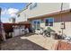 View of the backyard patio area featuring a sliding glass door and a red privacy fence at 1009 Milky Way, Thornton, CO 80260