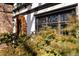 Close up of a Tudor home featuring an arched doorway decorated with autumnal wreaths and lush greenery at 124 N Marion St, Denver, CO 80218