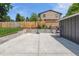 Large backyard space features a basketball court, grassy area, and a sturdy wooden fence, perfect for outdoor activities at 7359 S Jay St, Littleton, CO 80128