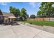 Beautifully landscaped backyard with patio, dining area, lush lawn, swing set, and a tall wooden fence for privacy at 7359 S Jay St, Littleton, CO 80128