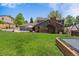 Overlooking backyard with a built-in trampoline and lush green grass at 7359 S Jay St, Littleton, CO 80128