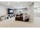 Finished basement featuring neutral carpet, recessed lighting, and a comfortable seating area with a large television at 7359 S Jay St, Littleton, CO 80128