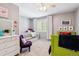 Bright bedroom featuring carpeted floors, ceiling fan, and -friendly decorations at 7359 S Jay St, Littleton, CO 80128