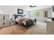 Calming bedroom with a ceiling fan, carpeted floor, large windows, and bright, natural light at 7359 S Jay St, Littleton, CO 80128