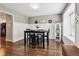 Elegant dining room with stylish wainscoting, rich wood flooring, and a bright window at 7359 S Jay St, Littleton, CO 80128