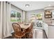 Bright dining room with a large window, and sliding glass door to the backyard patio at 7359 S Jay St, Littleton, CO 80128