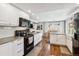 Modern kitchen with stainless steel appliances, white cabinetry, and granite countertops at 7359 S Jay St, Littleton, CO 80128