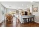 Bright kitchen and dining space featuring hardwood floors, and a kitchen island with bar seating at 7359 S Jay St, Littleton, CO 80128