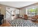 Stylish living room with wood floors, neutral walls, a large window, and trendy furnishings at 7359 S Jay St, Littleton, CO 80128