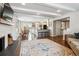 Open concept living space with fireplace flowing into the dining area and kitchen at 7359 S Jay St, Littleton, CO 80128