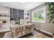 Bright office space with built-in shelves, a large window, and a unique accent wall at 7359 S Jay St, Littleton, CO 80128