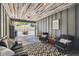 Inviting patio with a rustic wood ceiling, outdoor seating, and access to the backyard, perfect for relaxing or entertaining at 7359 S Jay St, Littleton, CO 80128