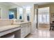 Elegant bathroom with double vanity, soaking tub, and walk-in shower at 87 S Ash, Denver, CO 80246