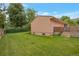Green backyard featuring a home with brick accents and a well-maintained lawn at 2309 E Floyd Pl, Englewood, CO 80113