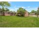 Expansive backyard featuring a spacious lawn and a charming sunroom, perfect for outdoor living at 2309 E Floyd Pl, Englewood, CO 80113