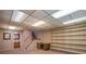 Spacious basement with carpeted stairs, built-in shelving, and access to a bathroom at 2309 E Floyd Pl, Englewood, CO 80113