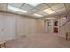 Large finished basement area with paneled walls and a door leading to another room at 2309 E Floyd Pl, Englewood, CO 80113