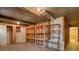 Unfinished basement with open shelving, concrete floor, and exposed ceiling at 2309 E Floyd Pl, Englewood, CO 80113