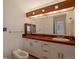 Bathroom featuring vintage style, vanity with decorative tile and wooden accents, and a large mirror at 2309 E Floyd Pl, Englewood, CO 80113
