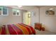 Cozy bedroom with bright striped bedding and natural light from the window at 2309 E Floyd Pl, Englewood, CO 80113
