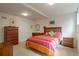Spacious bedroom with colorful bedding, multiple dressers and neutral carpeting at 2309 E Floyd Pl, Englewood, CO 80113