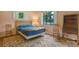 Inviting bedroom featuring hardwood floors and natural light from the windows at 2309 E Floyd Pl, Englewood, CO 80113