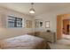 Inviting bedroom with a comfy bed, stylish dresser, and large window with shutter detail at 2309 E Floyd Pl, Englewood, CO 80113