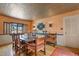 Dining room featuring decorative tin ceiling, hardwood floors, and custom lighting at 2309 E Floyd Pl, Englewood, CO 80113