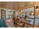 Dining room featuring decorative tin ceiling and an open view to kitchen and living room at 2309 E Floyd Pl, Englewood, CO 80113