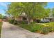 Charming single-story home with a well-manicured lawn and mature landscaping at 2309 E Floyd Pl, Englewood, CO 80113