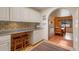 Bright kitchen with white cabinets, stainless steel appliances, and custom tiled backsplash at 2309 E Floyd Pl, Englewood, CO 80113
