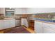 Bright kitchen with white cabinets, stainless steel appliances, and custom tiled backsplash at 2309 E Floyd Pl, Englewood, CO 80113