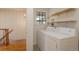 Convenient laundry area with a washer, dryer, and shelving for storage at 2309 E Floyd Pl, Englewood, CO 80113
