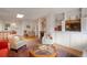 Bright living room featuring a skylight, fireplace, built-in shelving and comfortable seating at 2309 E Floyd Pl, Englewood, CO 80113