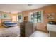 Spacious main bedroom featuring a large bed, stylish rug, and work station with natural light at 2309 E Floyd Pl, Englewood, CO 80113
