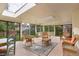 Enclosed sunroom with brick flooring, skylights, and a view of the outdoors at 2309 E Floyd Pl, Englewood, CO 80113