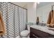 Clean bathroom with granite countertop vanity and decorative patterned shower curtain at 2592 Sweet Wind Ave, Castle Rock, CO 80109
