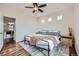 Bright and airy bedroom featuring large windows, a ceiling fan, and hardwood floors at 2592 Sweet Wind Ave, Castle Rock, CO 80109