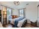 Cozy bedroom with wood floors, metal bed frame, and bright natural light at 2592 Sweet Wind Ave, Castle Rock, CO 80109