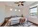 Bright and airy bedroom featuring large windows, a ceiling fan, and hardwood floors at 2592 Sweet Wind Ave, Castle Rock, CO 80109
