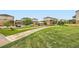 Community park with manicured lawns, multiple buildings, green spaces and covered seating at 2592 Sweet Wind Ave, Castle Rock, CO 80109