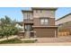 Two-story home featuring a covered front porch, garage and professionally landscaped front yard at 2592 Sweet Wind Ave, Castle Rock, CO 80109