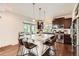 Spacious kitchen featuring a large island, granite countertops, stainless steel appliances, and access to a patio at 2592 Sweet Wind Ave, Castle Rock, CO 80109