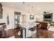 Kitchen island with bar stool seating, stainless steel appliances and view into the living room at 2592 Sweet Wind Ave, Castle Rock, CO 80109