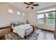 Bright and airy bedroom featuring large windows, a ceiling fan, and hardwood floors at 2592 Sweet Wind Ave, Castle Rock, CO 80109