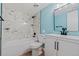 Updated bathroom design with white cabinets, marble-look shower and modern fixtures at 3141 S Tamarac Dr # 111G, Denver, CO 80231