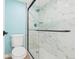 Modern bathroom featuring a glass enclosed shower with luxurious marble-look tile at 3141 S Tamarac Dr # 111G, Denver, CO 80231
