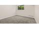 Cozy bedroom with neutral carpet and a bright window providing natural light at 3141 S Tamarac Dr # 111G, Denver, CO 80231