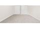Bright bedroom featuring plush carpet, fresh white trim, and a double door closet at 3141 S Tamarac Dr # 111G, Denver, CO 80231
